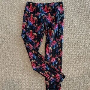 Black and rainbow leggings featuring sea turtles